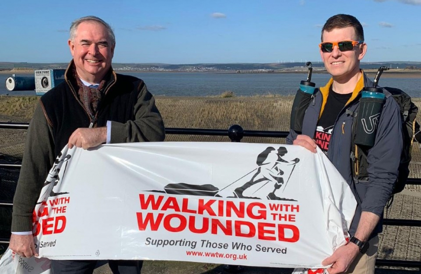 Geoffrey and Mr Ryan hold up a banner which reads: "WALKING WITH THE WOUNDED; Supporting Those Who Served."